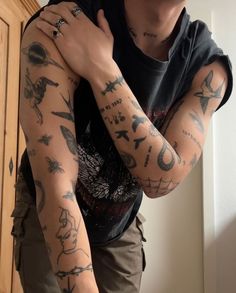 a man with tattoos on his arm and arms