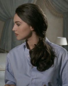 a woman with long hair wearing a blue shirt