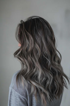 Long wavy brunette hair with ash grey highlights for added depth and dimension. Grey Hair Color Ideas For Brunettes, Dark Brunette Balayage Hair Ashy, Ash Grey Highlights On Brown Hair, Grey Brown Hair Balayage, Brunette Grey Hair, Adding Dimension To Dark Brown Hair, Ash Hair Color Grey, Icy Babylights, Dark Hair Ash Highlights