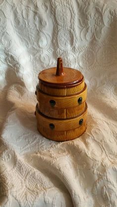 a wooden box sitting on top of a white blanket