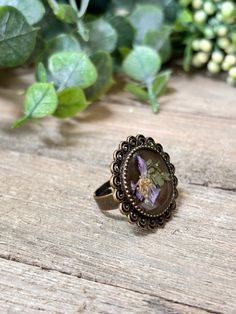 A handmade, one-of-a-kind, pressed flower and resin ring with a vintage bronze band. Size 6 with adjustable band. Adjustable Rings With Pressed Flowers, Vintage Silver Jewelry With Pressed Flowers, Nature-inspired Silver Jewelry With Pressed Flowers, Silver Heart-shaped Jewelry With Pressed Flowers, Purple Flower-shaped Jewelry With Pressed Flowers, Resin Ring, Flower Ring, Pressed Flowers, Rings Statement