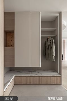 an open closet with clothes hanging on the wall