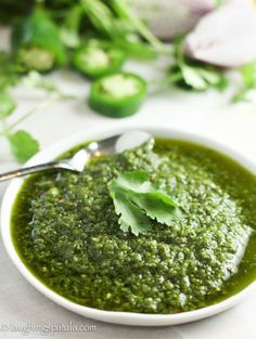 a white bowl filled with green pesto