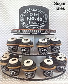 cupcakes are arranged on a tiered cake stand with the number forty nine