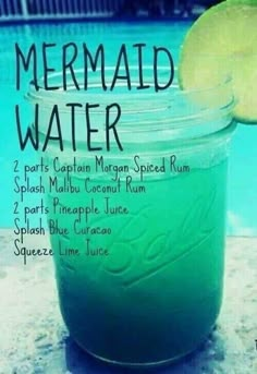 there is a blue drink in a mason jar with a lime slice on top and the words mermaid water written below it