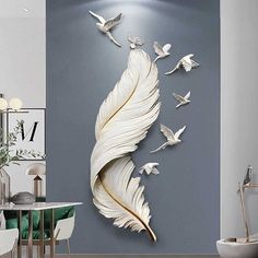 the wall is decorated with white birds and feathers