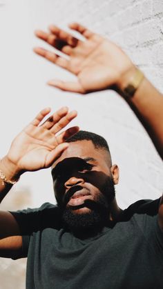 a man holding his hands up in the air