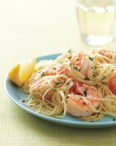 pasta with shrimp and parsley on a blue plate