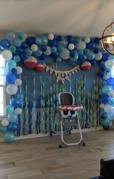 a room decorated with balloons and streamers