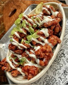 chicken wings covered in sauce and lettuce on a tray