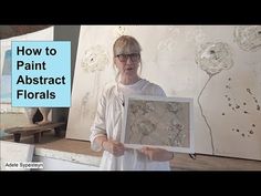 a woman holding up a piece of art in front of a white background with the words how to paint abstract florals