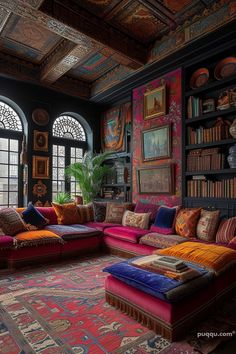 a living room filled with lots of furniture and bookshelves covered in colorful pillows