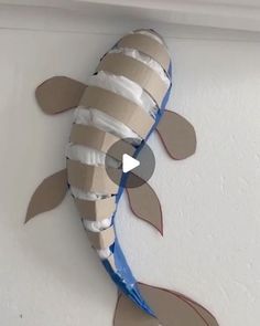 a fish made out of toilet paper on the wall