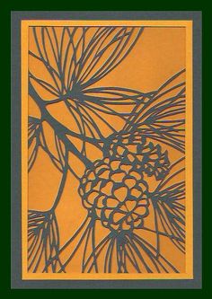 an orange and black paper with pine cones on it