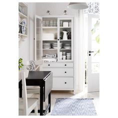 an image of a white cupboard with dishes on it's shelves and the words ikea below