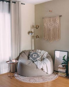 a living room filled with furniture and a large round rug on top of a hard wood floor