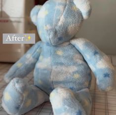 a blue teddy bear sitting on top of a table