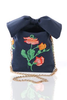 a small blue purse with flowers on it