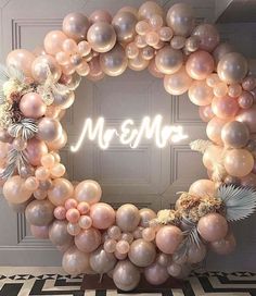 a wreath made out of balloons with the word mr and mrs on it