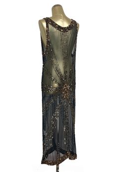 Elongating and ultra sexy, our Sunray Gown takes vintage luxe to the next level! Constructed on evening quality mesh, the gown is handbeaded in a stunning bronze and jet sunray design. With a liquid drape, the gown is full length and simply stunning. Sheer, so a slip is recommended. S/M.....bust 36", waist 34", hip measurement 40", length 52" L/XL.....bust 40", waist 38", hip measurement 44", length 52" 1920s Evening Gowns, Art Deco Panel, 1920s Looks, Deco Panel, Mesh Gown, 20s Fashion, 1930s Art Deco, Historical Fashion, Dream Clothes