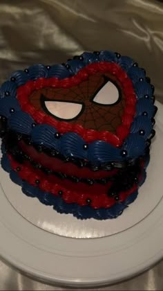 a spiderman cake on a white plate