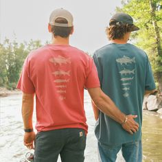 Whether you're casting a line in one of Montana's scenic rivers or simply want to display your love for fishing, this shirt is for you. Made with high-quality fabric, our Fish of Montana shirt offers a comfortable and breathable fit, perfect for your outdoor adventures or casual outings. Fit: Kyle is wearing a L in the Crimson. Ryan is wearing a XL in the Cactus. All the deets: Garment dyed for that lived in feel and almost no shrinkage at home. Soft ring-spun cotton fabric with 100% cotton thre Short Sleeve Tops For Summer Fishing, Short Sleeve Fishing Shirt For Summer, Short Sleeve Shirt For Summer Fishing, Casual Crew Neck Top For Fishing, Pre-shrunk Short Sleeve Fishing Shirt, Summer Fishing Tops With Crew Neck, Casual Crew Neck Shirt For Fishing, Casual Pre-shrunk T-shirt For Fishing, Graphic Print Shirt For Fishing In Summer