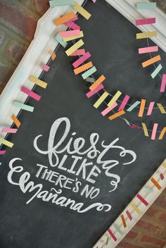 a chalkboard sign with colorful streamers on it that says fiesta like there is no manano