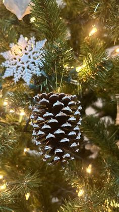 a pine cone ornament hanging from a christmas tree