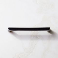 a black handle on a white marble surface