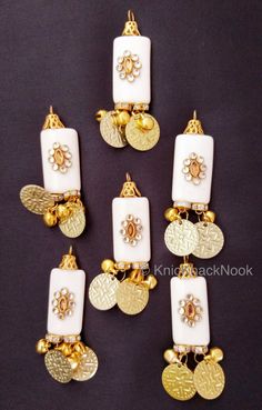 This listing is for a lovely White And Gold Beaded Tassels  With Gold Coins Latkan, Kundan Beads, Belly Dancing, Indian Latkans, Beaded Danglers. This is a very special KnicKnackNook find which you will not find anywhere else. End to End Length: 65 mm x 15 cm This listing is for 2 pieces. Great for jewellery making, embellishing bags, clutches, jeans, dresses, table topper, scrap-booking and many other crafts and sewing projects. Tassels Fashion Clothing, Bridal Trim, Rakhi Design, Easter Fabric, Embellished Bags, White Tassel, Tassels Fashion, Floral Craft, Beaded Collar