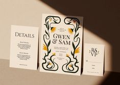 three wedding stationery cards on top of each other