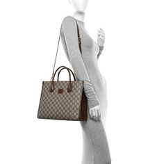 This is an authentic GUCCI GG Supreme Monogram Azalea Calfskin Small Retro Interlocking G Tote Bag in Beige, Ebony, and Brown Sugar. This stylish tote is crafted of classic Gucci GG supreme monogram coated canvas. The bag features ivory leather handles, optional adjustable shoulder strap, and gold hardware. The bag has an open top with a beige microfiber interior and a pocket. Leather Handles, Open Top, Leather Handle, Brown Sugar, Gold Hardware, Calf Skin, Shoulder Strap, Handles, Monogram