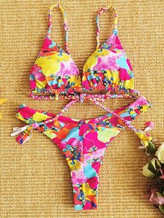 Floral-Print Triangle Split Bikini Swimsuit Multicolor Printed Halter Neck Swimwear, Vibrant Swimwear For Sunbathing In Spring, Vibrant Pink Floral Print Swimwear, Pink One-piece Swimwear For Festival, Pink Fitted Hawaiian Swimwear, Beach Season Floral Print Swimwear, Vibrant Multicolor Floral Print Swimwear, Tropical Lined Swimwear For Spring, Pink Triangle Top Printed Swimwear