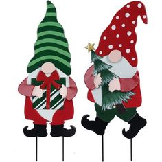 two christmas gnomes standing next to each other