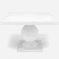 a white table with a vase on it's base and the top covered in frosting