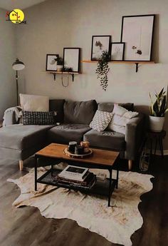 a living room filled with furniture and pictures hanging on the wall above it's coffee table