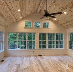 an empty room with wood flooring and windows on the ceiling is shown in this image