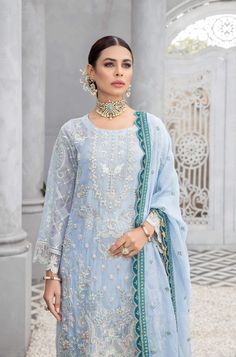 Blue Pakistani Dress in Kameez Sharara Dupatta Style is an elegant masterpiece emblazoned with embroidery and luxury designs. Shimmering details and silverwork give a perfect finishing look to the Pakistani Wedding Dress, making it an epitome of beauty. Embroidered Kameez The beautiful kameez has an elegant blue color and is beautifully emblazoned with lavish embroidery work, threads, tilla, and sequins. Hand-crafted details of stones, beads, and motifs enhance the charm of this perfectly stitch Designer Elegant Sharara With Naqshi Details, Elegant Designer Sharara With Naqshi Details, Formal Organza Kurta With Naqshi Detailing, Formal Naqshi Organza Kurta, Elegant Embroidered Dress With Traditional Drape For Eid, Elegant Semi-stitched Sharara With Naqshi Details, Formal Sharara With Naqshi In Traditional Drape, Organza Salwar Kameez With Naqshi For Reception, Elegant Sharara With Naqshi For Eid