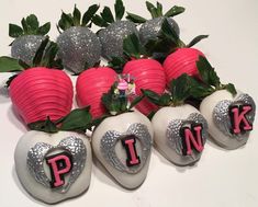 some strawberries with pink letters on them