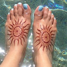 a person's feet with hendix painted on them in the clear water