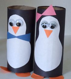 two penguins made out of toilet paper with googly eyes