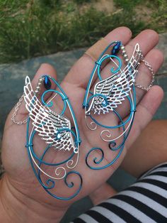 Wings Peacock Blue and Silver You will receive a right and a left with this order. This is made to order in 3 to 5 business days of purchase. Elf ear cuffs are lightweight, stylish and one size fits all. You'll find a pair that is suitable for any event be at the Renaissance Fair, a fairy festival, or just a fun night out on the town! All Elf Ear Cuffs are made with artistic wire, silver plated non-tarnish copper, Nickel free. All Cuffs come as a set and easily fit any size ear by gently adjusti Blue Fairy Jewelry For Party, Blue Fairy-style Jewelry For Party, Handmade Blue Fantasy Jewelry, Whimsical Blue Jewelry For Parties, Elf Jewelry, Fantasy Crown, Elf Ear, Elf Ear Cuff, Fairy Festival