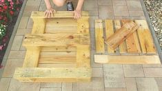 a person kneeling down next to some wooden pallets