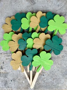 a bunch of wooden shamrocks sitting on top of a cement floor