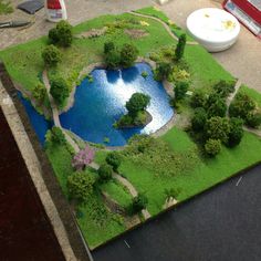 a fake pond surrounded by grass and trees