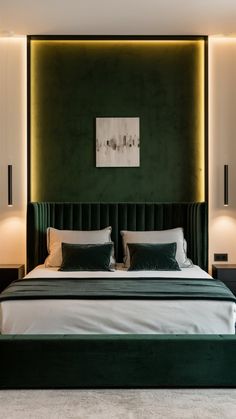 a bed with green velvet headboard and white linens in a modern bedroom setting