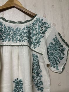 Mexican style hand-embroidered blouse is made from 100% cotton soft and light which makes you so comfortable. Split sleeve is tighten with hand crochet. Color : Ivory/ green embroidery Measurement is laid flat in inches (approximately) - one size fits most (S-L). Loose style depend on preferred fit - arm hole : 20" - bust : 42" - sleeve length : 7.5" - waist : open - hips : 52" - shoulder to bottom hem : 27" More beautiful blouses link : http://www.etsy.com/shop/chokethai?section_id=11663201 Bohemian Embroidered Relaxed Fit Blouse, Artisan Embroidered Tops For Summer, Artisan Embroidered Summer Top, Folk Style Cotton Peasant Top With Floral Embroidery, Summer Cotton Peasant Top With Intricate Embroidery, Embroidered Bohemian Peasant Top With Relaxed Fit, Cotton Peasant Blouse With Intricate Embroidery, Bohemian Embroidered Peasant Top With Relaxed Fit, Bohemian Embroidered Relaxed Fit Peasant Top