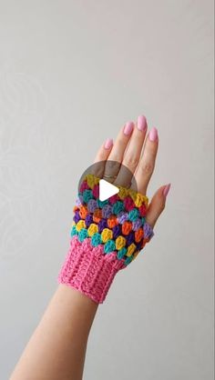 a woman's hand with colorful crochet bracelets