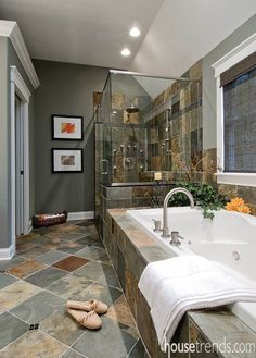 a bath room with a tub a sink and a window