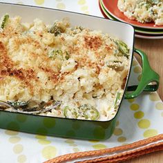 a casserole dish with broccoli and cheese in it on a table